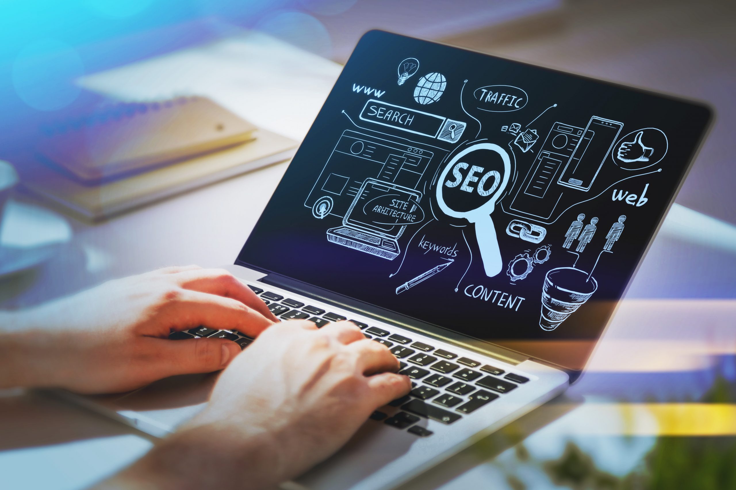 Businessman hands working on laptop at office workspace to discover search engine optimization to succeed in start up. SEO icons sketch on glass screen.