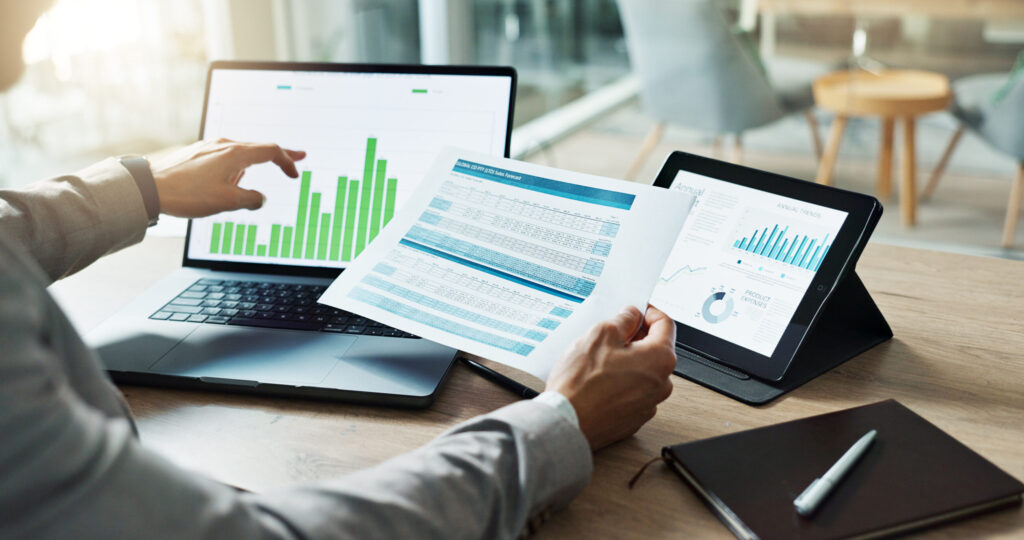Hands, laptop and chart with paper for business man, analysis or check progress of economy, investment or profit. Financial agent, pc and reading graph for data document, growth or numbers for future