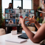 African american startup employee working from home gesturing in video conference with colleagues